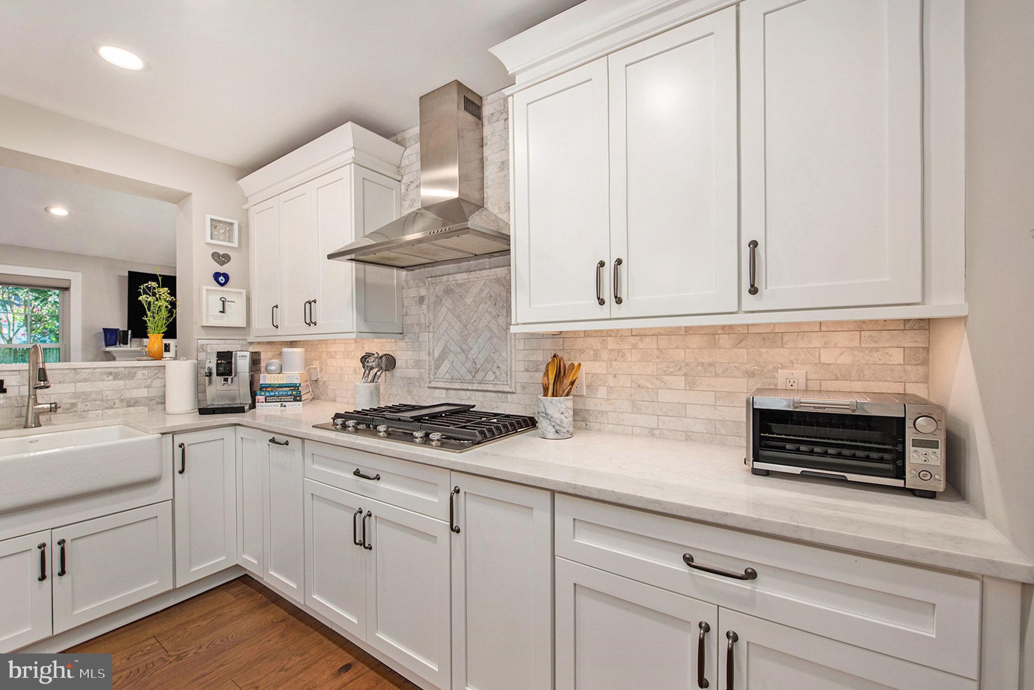 109 Willowburn Road Villanova, PA 19085 - Photo 21 of 65 a kitchen with stainless steel appliances white cabinets and a stove