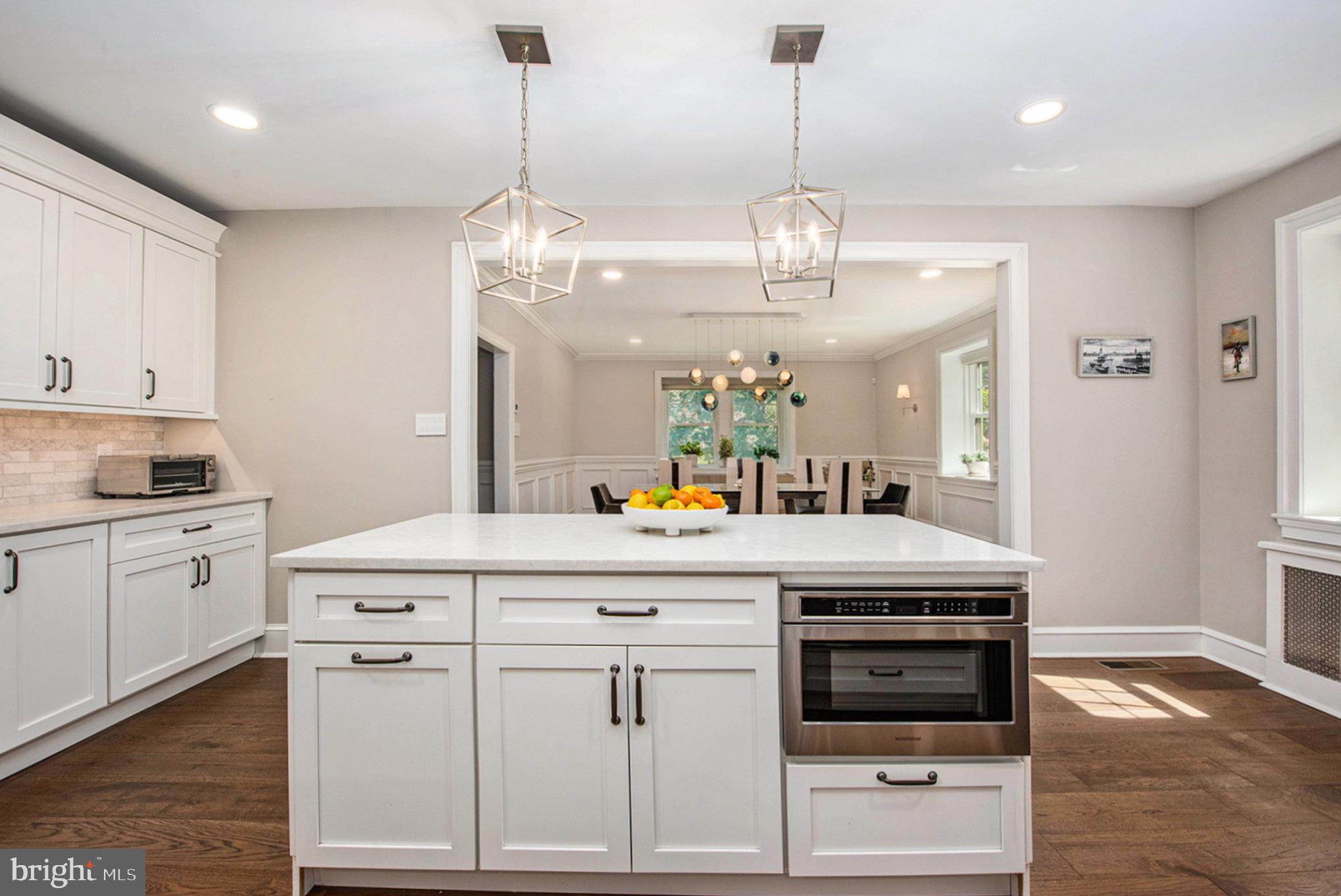 109 Willowburn Road Villanova, PA 19085 - Photo 23 of 65 a kitchen with stainless steel appliances granite countertop a stove and white cabinets