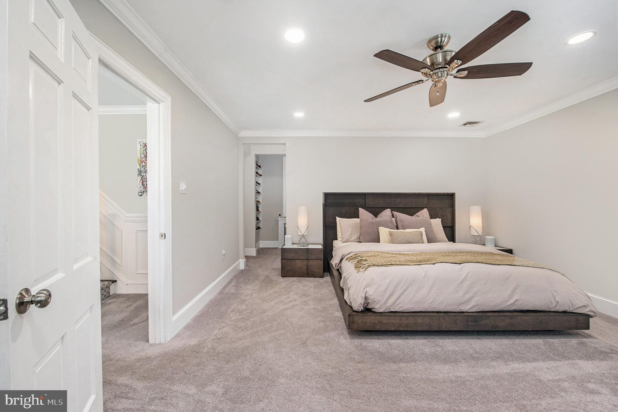 109 Willowburn Road Villanova, PA 19085 - Photo 31 of 65 a bedroom with a bed and a chandelier