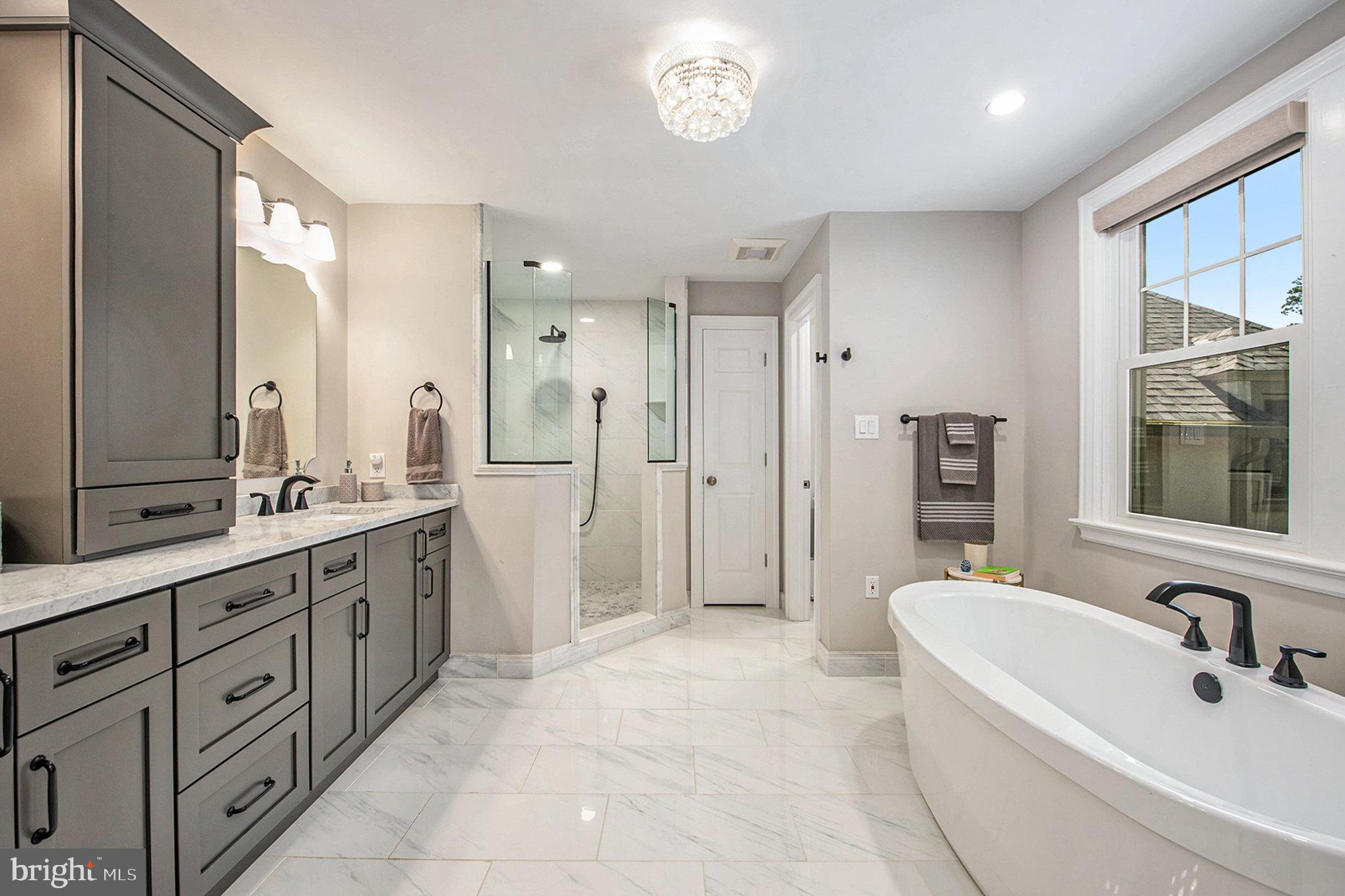 109 Willowburn Road Villanova, PA 19085 - Photo 35 of 65 a spacious bathroom with a double vanity sink a mirror a bathtub and shower