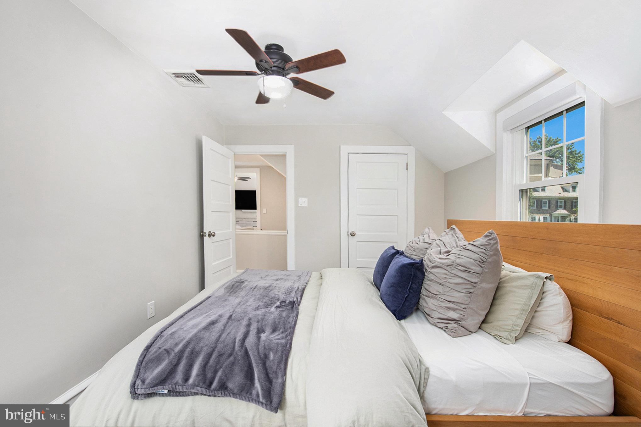 109 Willowburn Road Villanova, PA 19085 - Photo 46 of 65 a bedroom with a large bed and a chandelier