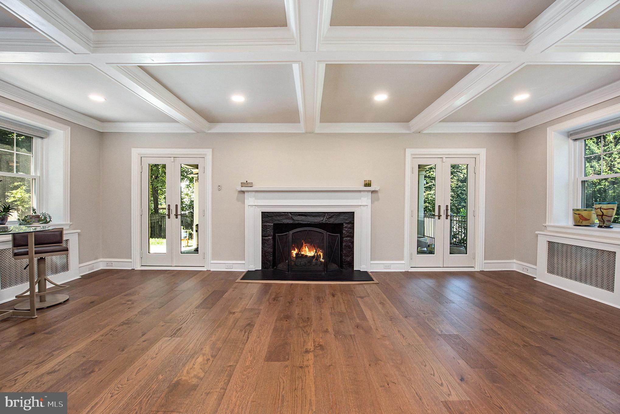 109 Willowburn Road Villanova, PA 19085 - Photo 9 of 65 a view of an empty room with wooden floor a fireplace and a window