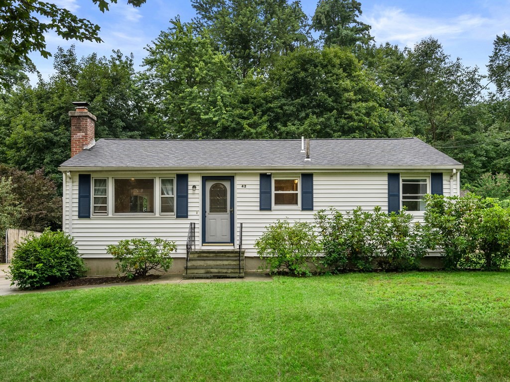 a aerial view of a house next to a yard