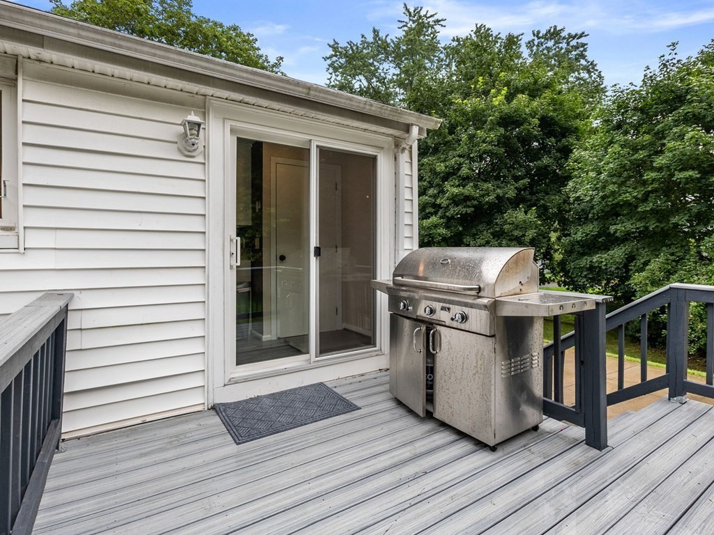 42 Priest Street Hudson, MA 01749 - Photo 20 of 23 a view of a deck with wooden floor and fence with a floor to ceiling window and wooden floor