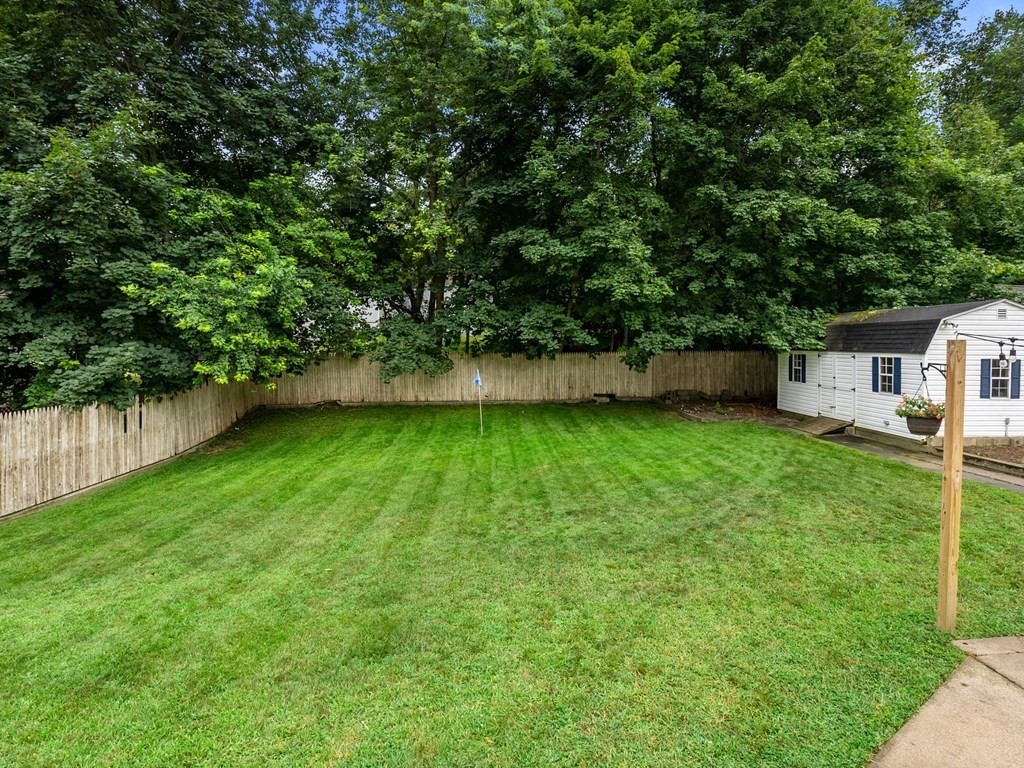 42 Priest Street Hudson, MA 01749 - Photo 21 of 23 a view of a backyard with a small cabin