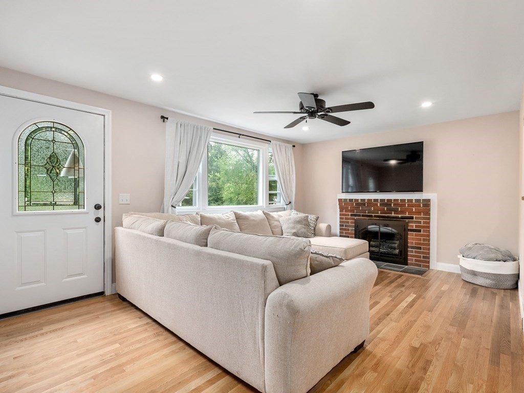 42 Priest Street Hudson, MA 01749 - Photo 3 of 23 a living room with furniture a fireplace and a flat screen tv