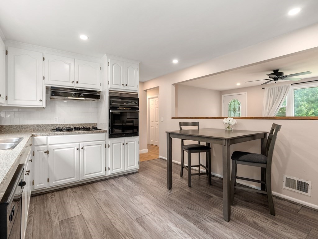 42 Priest Street Hudson, MA 01749 - Photo 6 of 23 a kitchen with stainless steel appliances granite countertop a white cabinets and wooden floors