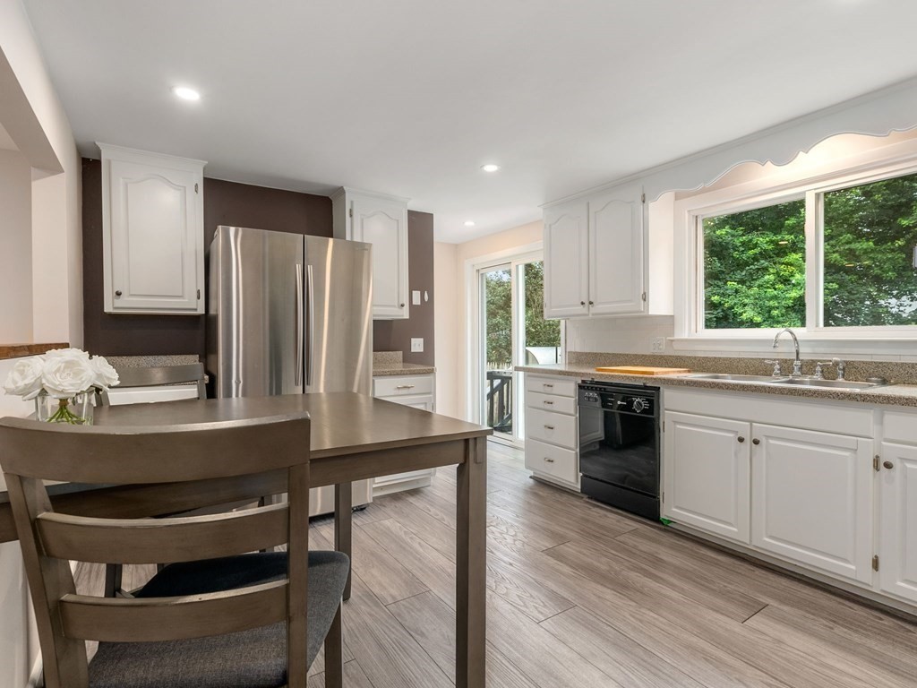 42 Priest Street Hudson, MA 01749 - Photo 7 of 23 a kitchen with kitchen island a stove a sink and a refrigerator