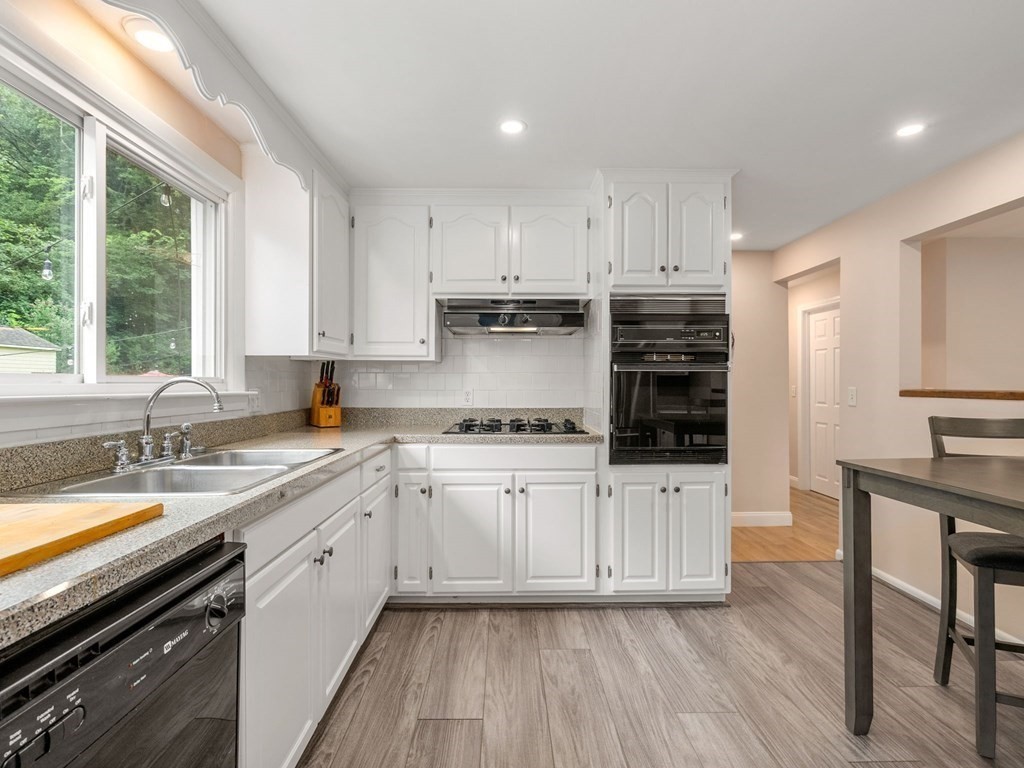 42 Priest Street Hudson, MA 01749 - Photo 8 of 23 a kitchen with sink a microwave and cabinets