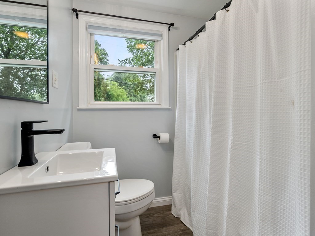 42 Priest Street Hudson, MA 01749 - Photo 10 of 23 a bathroom with a sink a toilet and a window