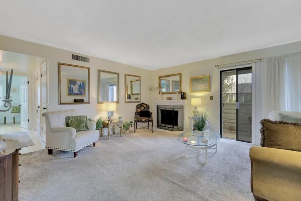 a living room with furniture and a fireplace