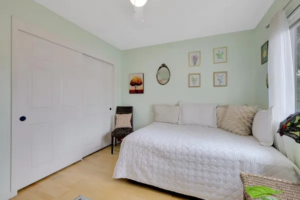 a bedroom with a bed and painting on the wall