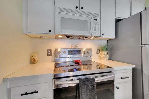 a kitchen with stainless steel appliances a cabinets and stove top oven