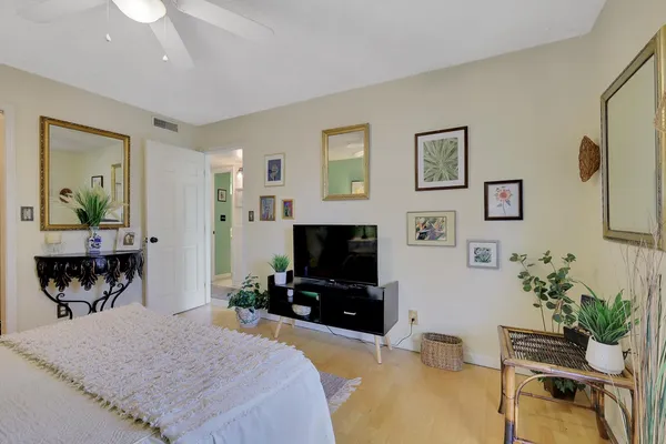 a bedroom with furniture and a flat screen tv