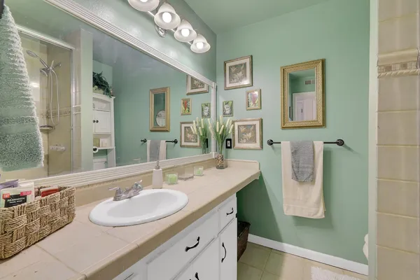 a bathroom with a sink double vanity and a mirror
