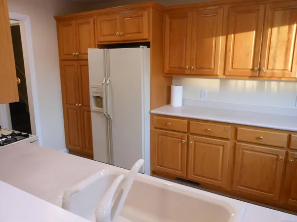 a kitchen with cabinets and a refrigerator