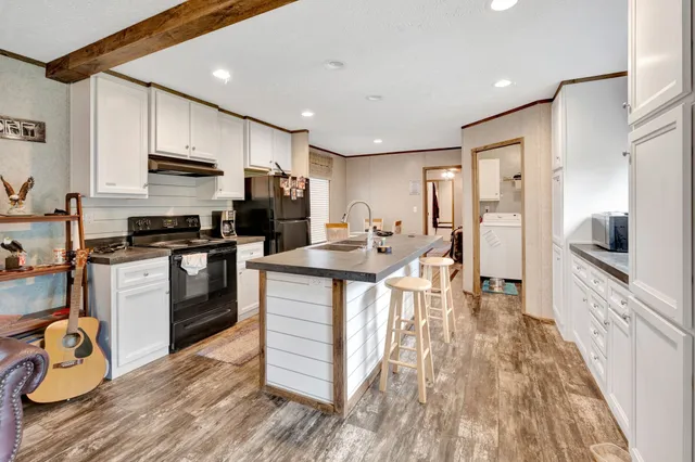 a kitchen with kitchen island a stove a sink and a refrigerator