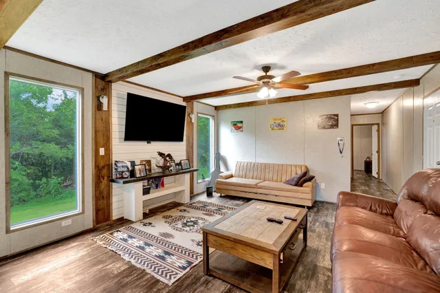 a kitchen with a table chairs and wooden floor