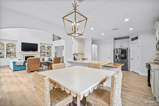 a kitchen with granite countertop white cabinets and stainless steel appliances