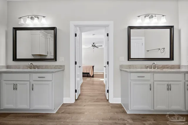 a view of a big room with windows and chandelier fan