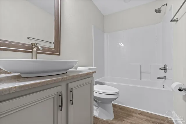 an aerial view of a house with a yard and lake