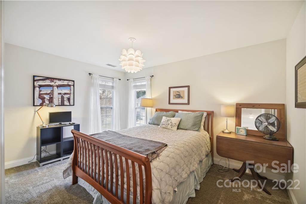 5533 Alexandrite Way Fort Mill, SC 29708 - Photo 16 of 27 a bedroom with a bed and a chandelier