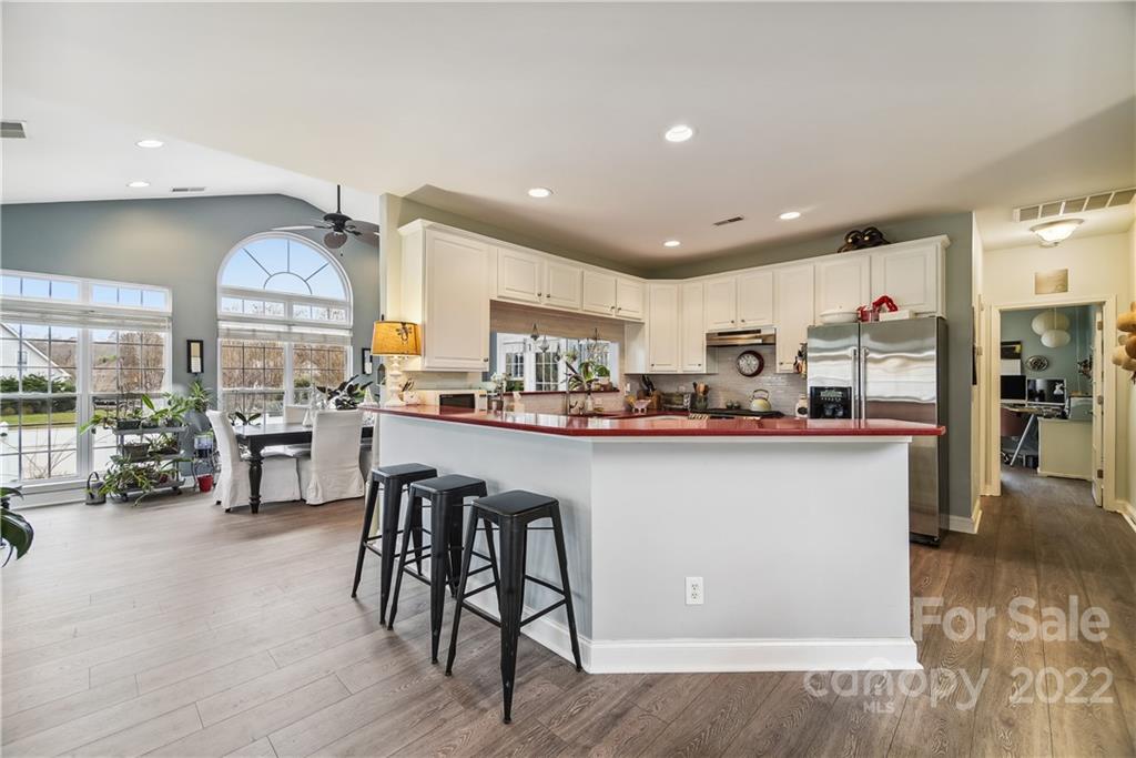 5533 Alexandrite Way Fort Mill, SC 29708 - Photo 6 of 27 a kitchen with stainless steel appliances granite countertop a refrigerator a stove and a wooden floors