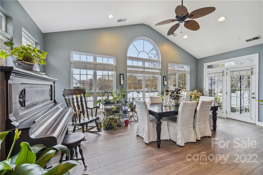 5533 Alexandrite Way Fort Mill, SC 29708 - Photo 8 of 27 a dining room with furniture a chandelier and wooden floor