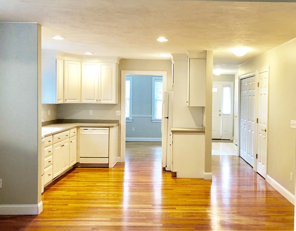 120 Summer Road, Unit 120 Boxborough, MA 01719 - Photo 3 of 6 a kitchen with stainless steel appliances granite countertop a refrigerator and a sink