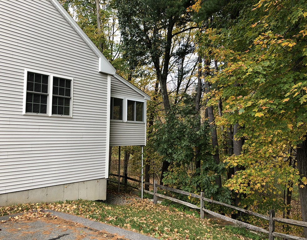 120 Summer Road, Unit 120 Boxborough, MA 01719 - Photo 6 of 6 a view of a house with a backyard