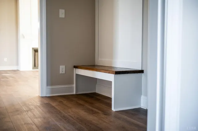 a view of empty room with wooden floor and ceiling fan