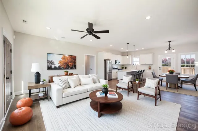 a kitchen with granite countertop a stove a microwave a sink and cabinets