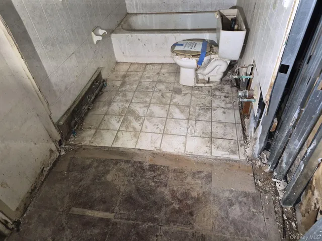 a bathroom with a toilet and shower