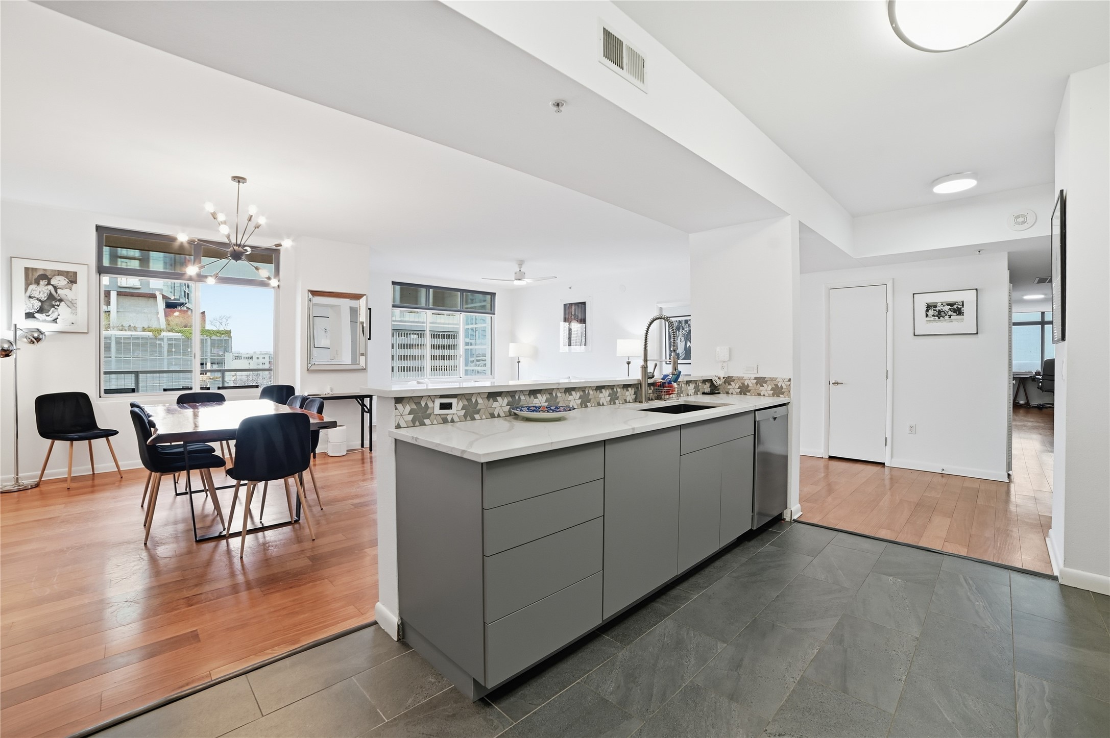54 Rainey Street, Unit 1018 Austin, TX 78701 - Photo 10 of 32 a large white kitchen with a large window and kitchen island