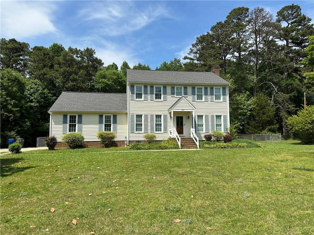 241 Olde Quarry Road Graham, NC 27253 - Photo 1 of 30 a front view of a house with a garden and trees