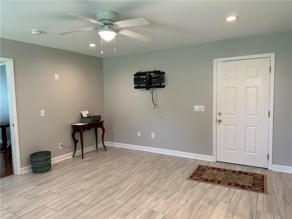 241 Olde Quarry Road Graham, NC 27253 - Photo 16 of 30 wooden floor with windows and a ceiling fan in a room