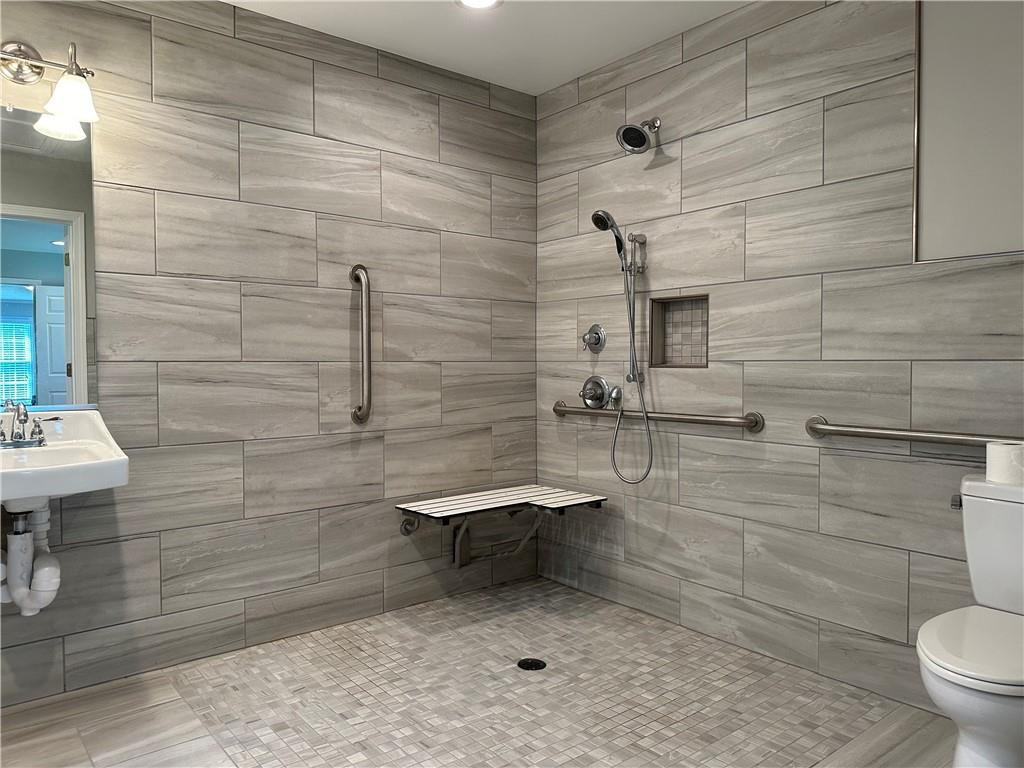 241 Olde Quarry Road Graham, NC 27253 - Photo 17 of 30 a bathroom with a sink a toilet and mirror