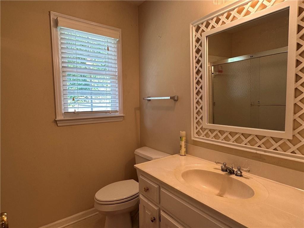 241 Olde Quarry Road Graham, NC 27253 - Photo 23 of 30 a bathroom with a sink a toilet and shower