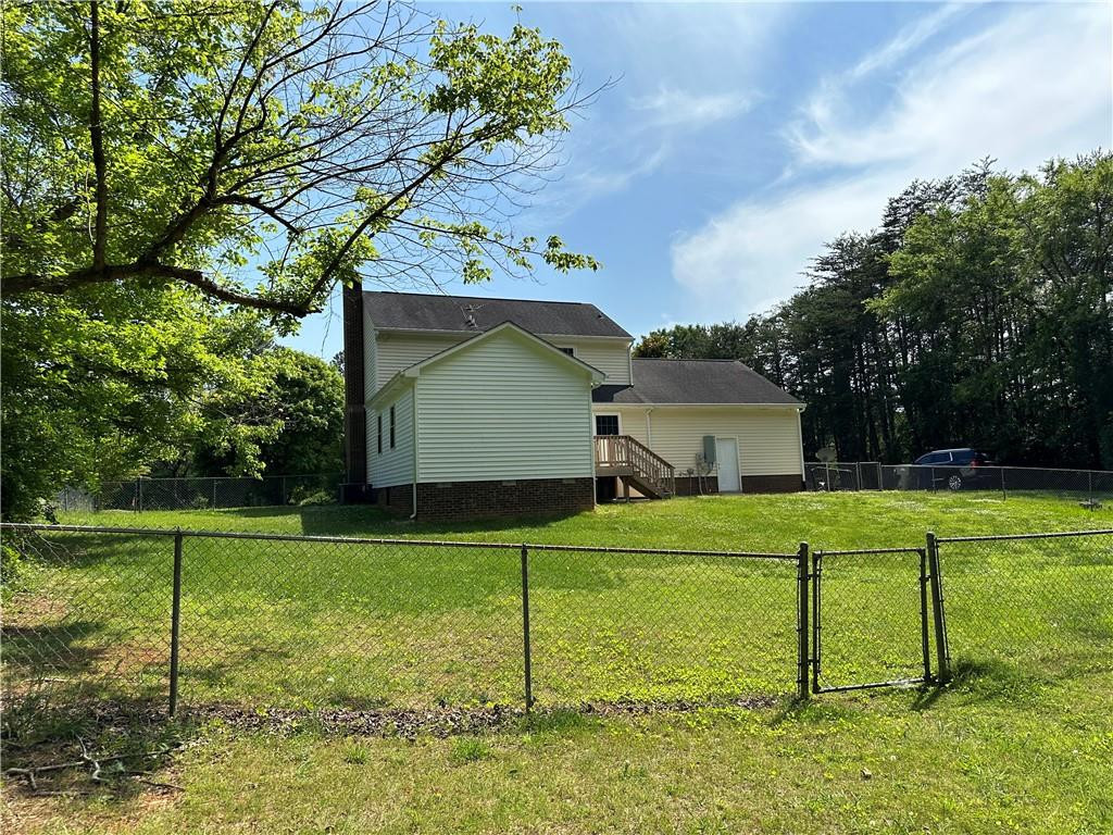 241 Olde Quarry Road Graham, NC 27253 - Photo 3 of 30 a house view with a play ground in front of it