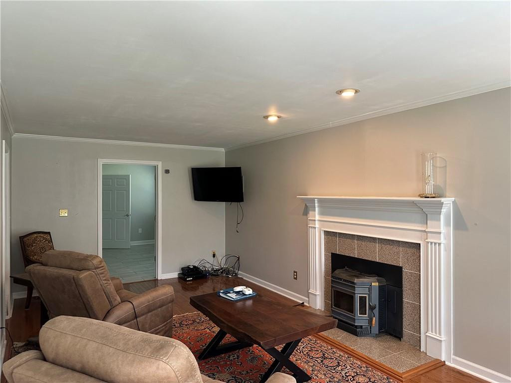 241 Olde Quarry Road Graham, NC 27253 - Photo 5 of 30 a living room with furniture a fireplace and a flat screen tv