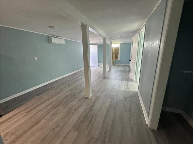 a view of a room with wooden floor