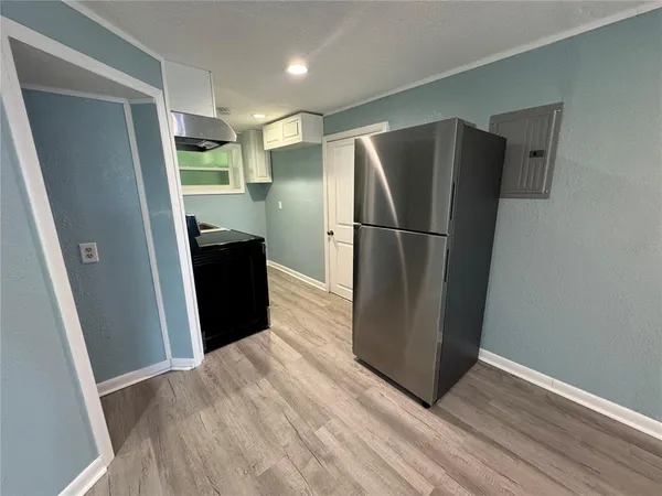 a view of a refrigerator in kitchen and wooden floor