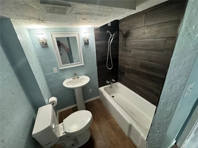 a bathroom with a sink toilet and shower