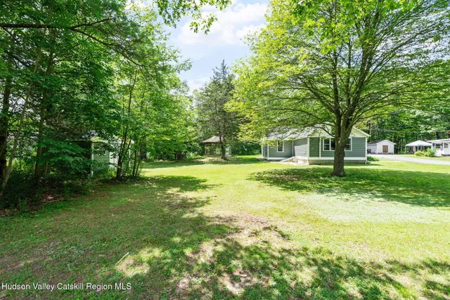 a view of a trees in front of a big yard