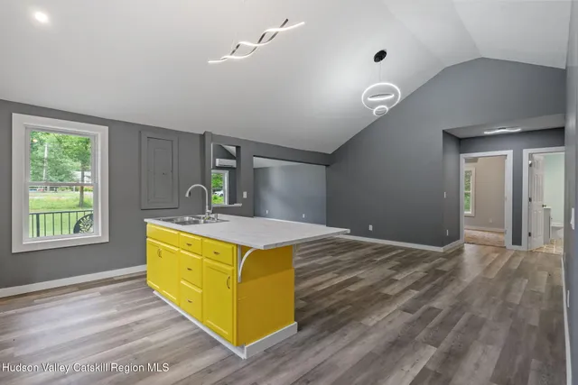 a view of a room with wooden floor and window