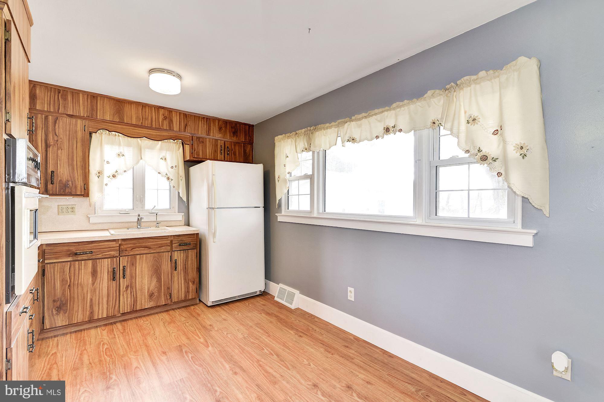 16 Stanger Road Bridgeton, NJ 08302 - Photo 14 of 34 a kitchen with granite countertop white cabinets white appliances a sink and a large window