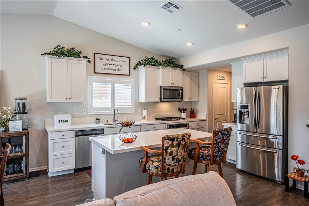 28340 Memory Lane Winchester, CA 92596 - Photo 11 of 39 a kitchen that has a lot of cabinets a sink and appliances in it