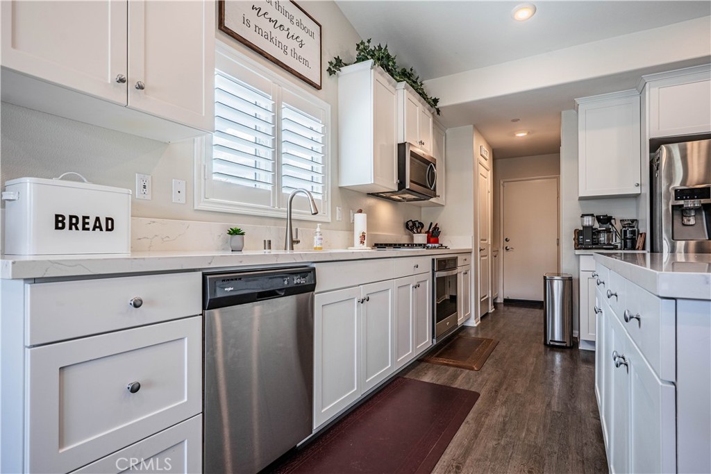 28340 Memory Lane Winchester, CA 92596 - Photo 13 of 39 a kitchen with white cabinets and white appliances
