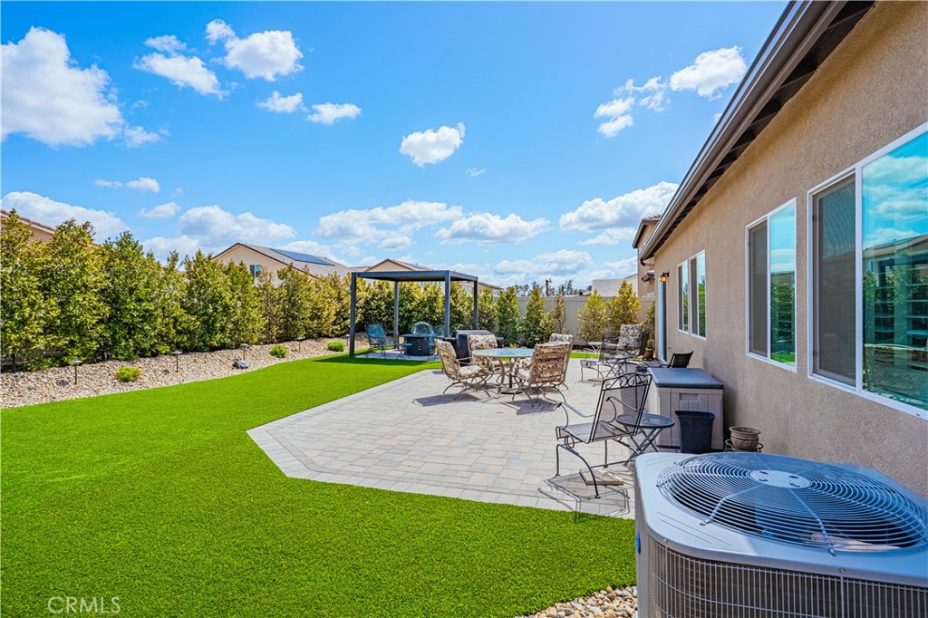 28340 Memory Lane Winchester, CA 92596 - Photo 33 of 39 a view of a patio with couches and table and chairs and potted plants