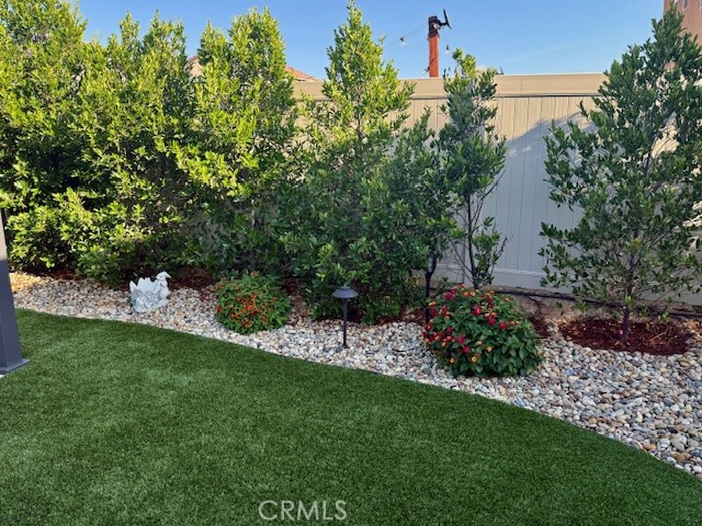 28340 Memory Lane Winchester, CA 92596 - Photo 34 of 39 a view of a garden with plants and a bench